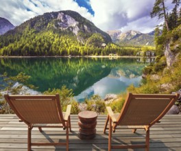 Pair of sun loungers on the lake. Magnificent lake in South Tyrol, Italy. The concept of walking