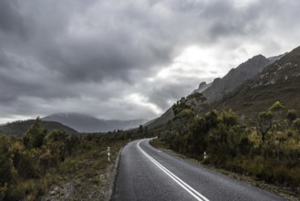 The picturesque Gordon River Rd at the Sentinel range of mountains near Bitumen Bones Sculpture on