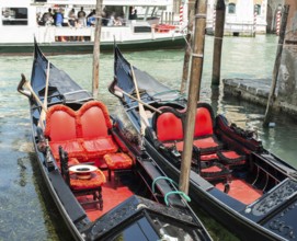 Ancient gondolas boat in Venice. Gondola red color interior