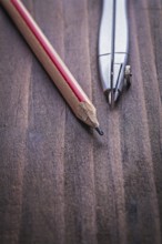 Very close up view compass and pencil on vintage wooden board learning concept learning concept