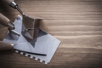 Scraper surfacer putty knife on wooden board