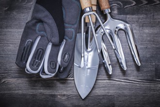 Stainless shovel rake trowel fork safety gloves gardening concept