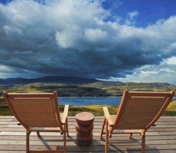 Two comfortable wooden sun loungers on the shore of the lake. Torres del Paine National Park.