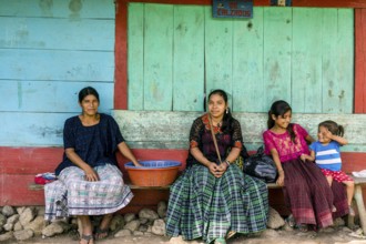 Women in front of a colorful wall, Lancetillo, La Parroquia, Reyna area, Quiche, Guatemala, Central