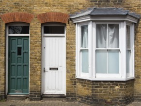 Traditional English house front entrance with door and windows