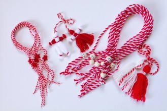 Bulgarian symbols of spring, many different white and red martenitsa on white background