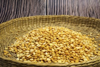 Brown bowl full of dry pea. Healthy eating and vegetarian concept