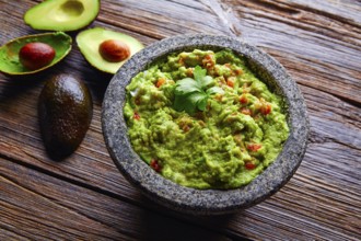 Avocado Guacamole on molcajete real Mexican traditional procedure