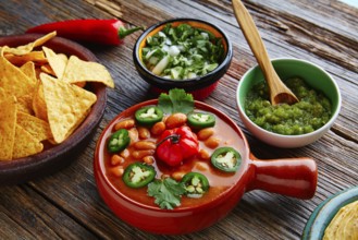 Frijoles charros mexican beans with chili pepper sides and tortillas