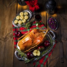 Festive stuffed roast goose with red cabbage and dumplings