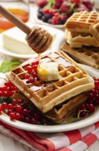 Belgian waffles served with butter red currants and honey