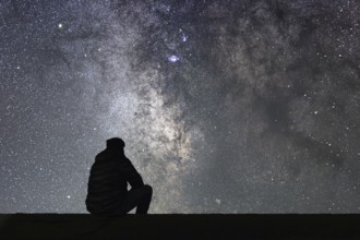 Man looking at the stars. Alone man looking at starry sky. Night sky
