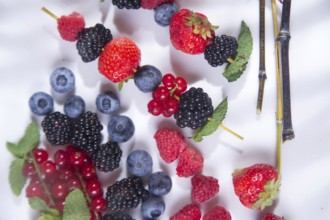 Presentation skewers variety of berries, fruits typical summer