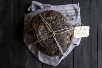 Fresh baked homemade bread on a black wooden table. Above view image