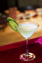 Modern blue martini cocktail with lime in bar