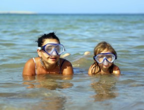 Happy summer vacation, snorkeling daughter with mother