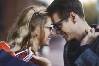 Picture showing young couple shopping in the city. Portrait of a couple with shopping bags in the