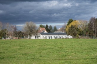 Merchtem, Flemish Brabant Region, Belgium, Feb. 25 2023, Green meadows and glasshouses at a Belgian