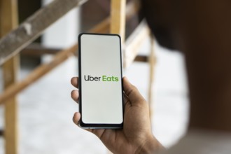 Uber Eats logo is displayed on smartphone