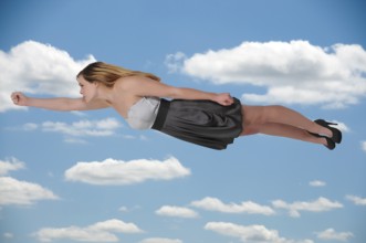 Beautiful young woman flying through the sky