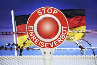 Police trowel with the inscription Stop Entry Ban in front of the German flag and barbed wire,