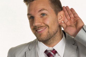 A man (entrepreneur or manager) holds his hand to his ear Austria