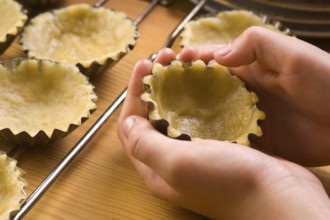 Detail of child hands making cookies, lodz, poland