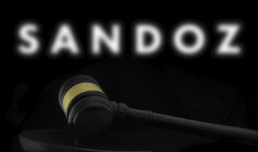 Court gavel in front of the Sandoz logo. Sandoz Group AG is a Swiss company generic pharmaceuticals