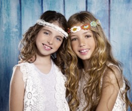 Children friends beautiful girls hippie retro style smiling together on blue wood