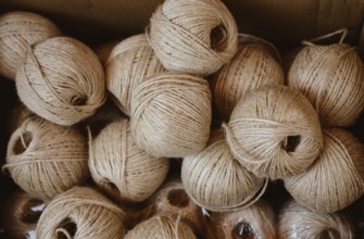 Plenty of spools or rolls of brown color linen string