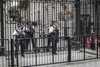 London, UK, August 18, 2015: Police officers protecting the gate of Downing street in London, the