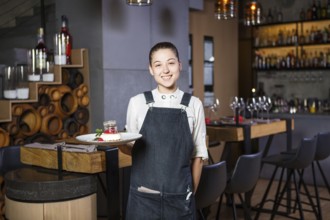 Ganson, officers, beautiful deushka with a smile and gathered hair in working form apron accepts an