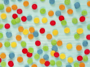 Border frame of colorful sprinkles on blue background. Top view or flat lay