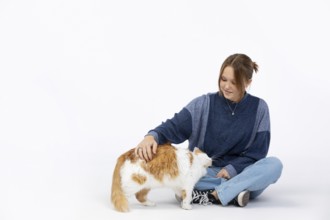 A joyful moment shows a woman petting her cat, highlighting their bond and the love between pets