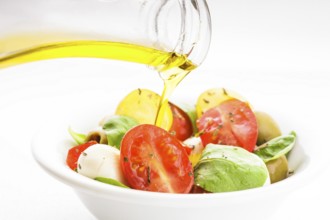 Fresh salad with tomatoes, mozzarella and olive oil