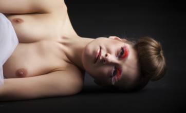 Female beauty portrait with tutu in front of a dark background