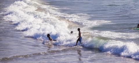 People swim, surf and play in the water