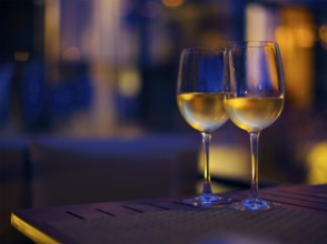 Two glasses of the white wine in the night. Close up. DOF