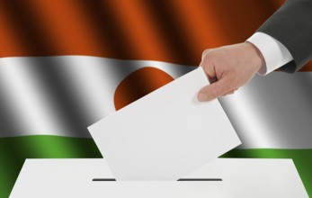 The Niger flag and the hand with the bulletin about the ballot box