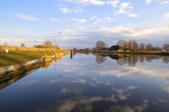 Dutch farmhouse by wide river, Groningen