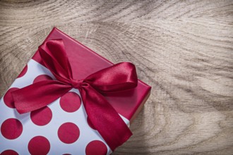 Red present box on wooden board celebrations concept