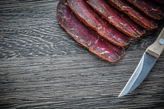 Sliced meat knife on wooden board