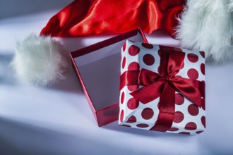 Santa hat wrapped gift box on white background