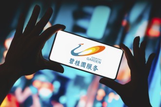 In this photo illustration, the Country Garden logo is displayed on a smartphone screen