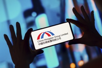 In this photo illustration, the China Hongqiao Group Limited logo is displayed on a smartphone