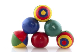 Many colorful juggle balls with stripes isolated over white