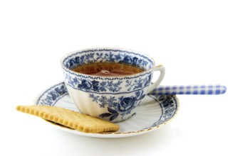 Cup of tea with a cookie isolated over white