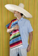 Mexican man serape poncho hat sombrero yellow stripes background