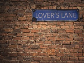 Lover's Lane Sign On A Grungy Old Red Brick Wall