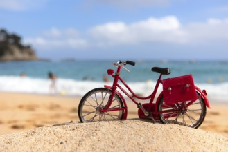 Red female bike at the beach